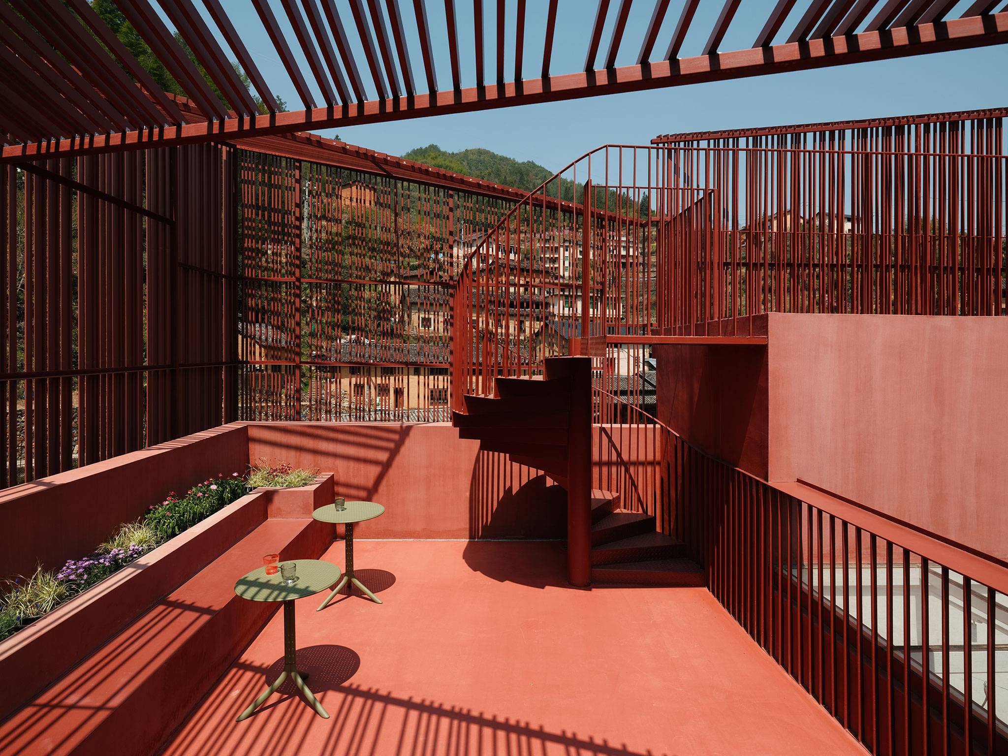 The outdoor spiral staircase extended from the handrail guides the audience to the highest level. The Quartet – Songzhuang Z Museum by TEAM_BLDG. Photograph by Jonathan Leijonhufvud. The outdoor spiral staircase extended from the handrail guides the audience to the highest level. The Quartet – Songzhuang Z Museum by TEAM_BLDG. Photograph by Jonathan Leijonhufvud.