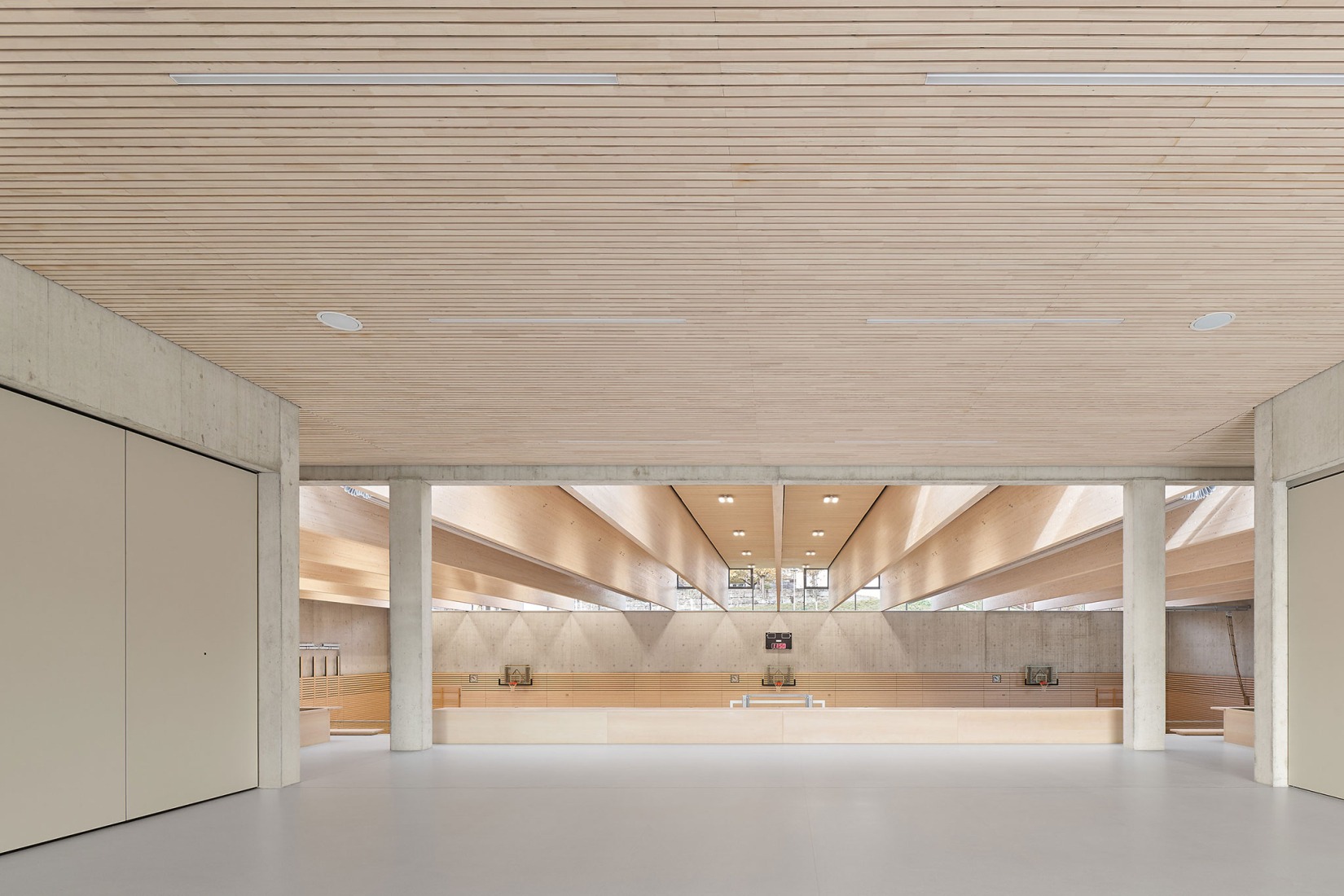 Three-pitch sports hall by Drei Architekten. Photograph by Zooey Braun.