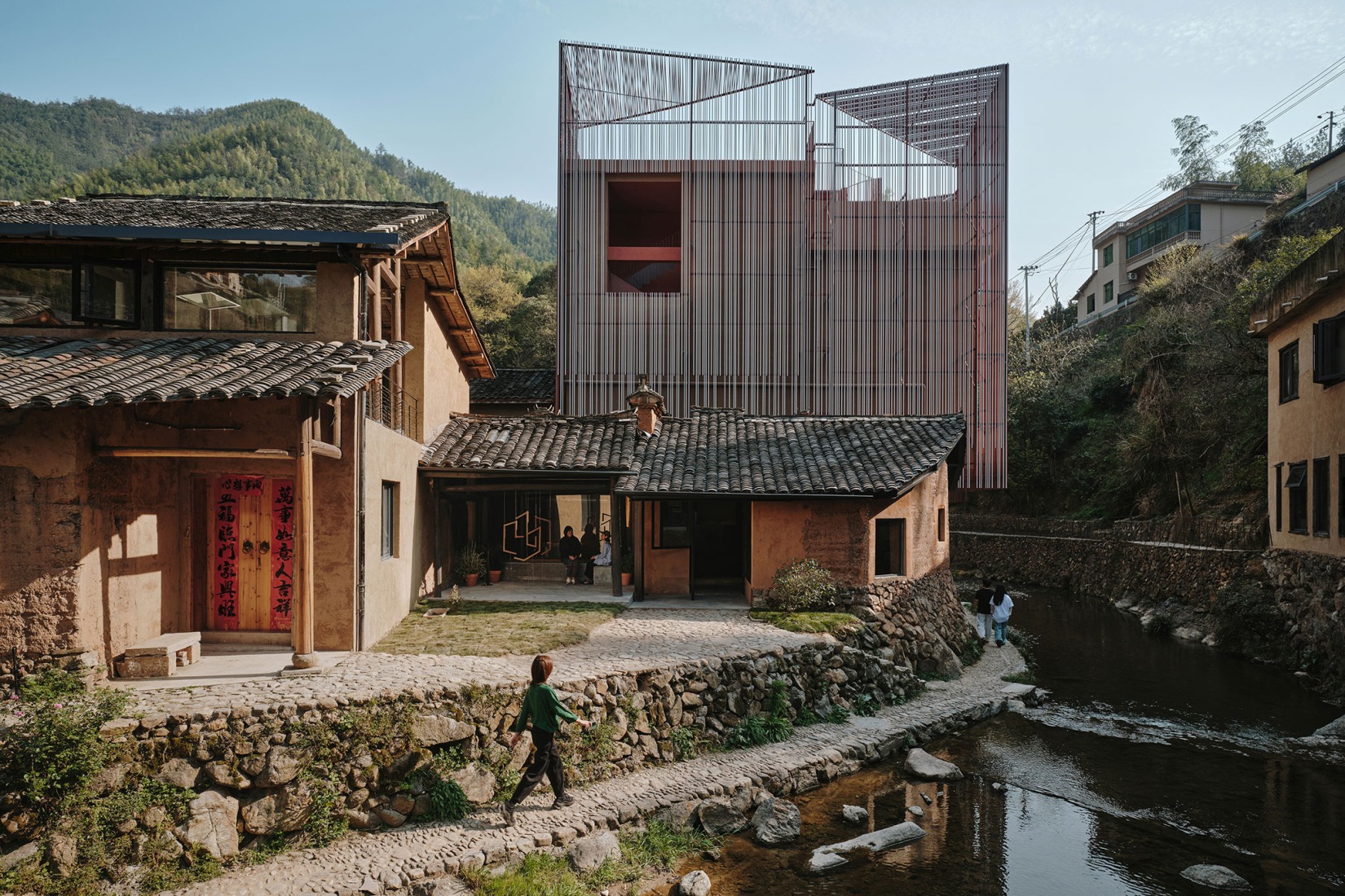 The existing rammed earth old house serves as the entrance to Z Museum. Songzhuang Z Museum by Team_BLDG. Photograph by Jonathan Leijonhufvud.