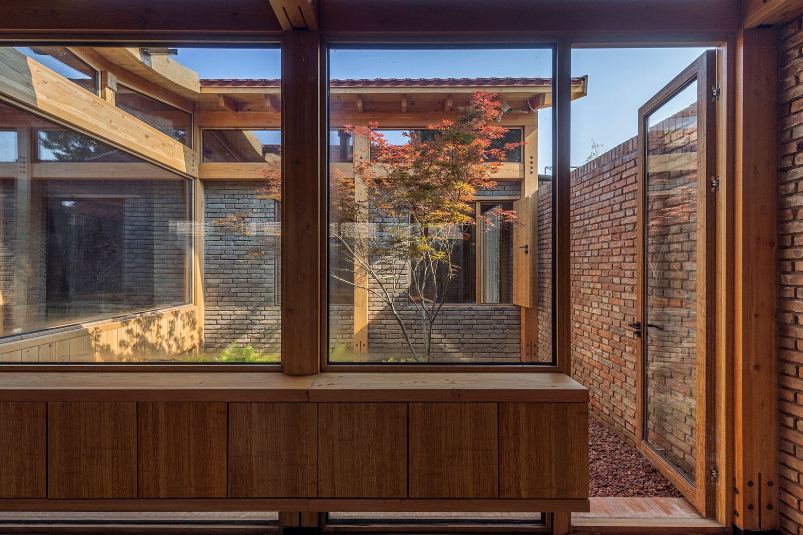 Access from Living room to courtyard. Mixed House by ARCHSTUDIO. Photograph by Jin Weiqi.