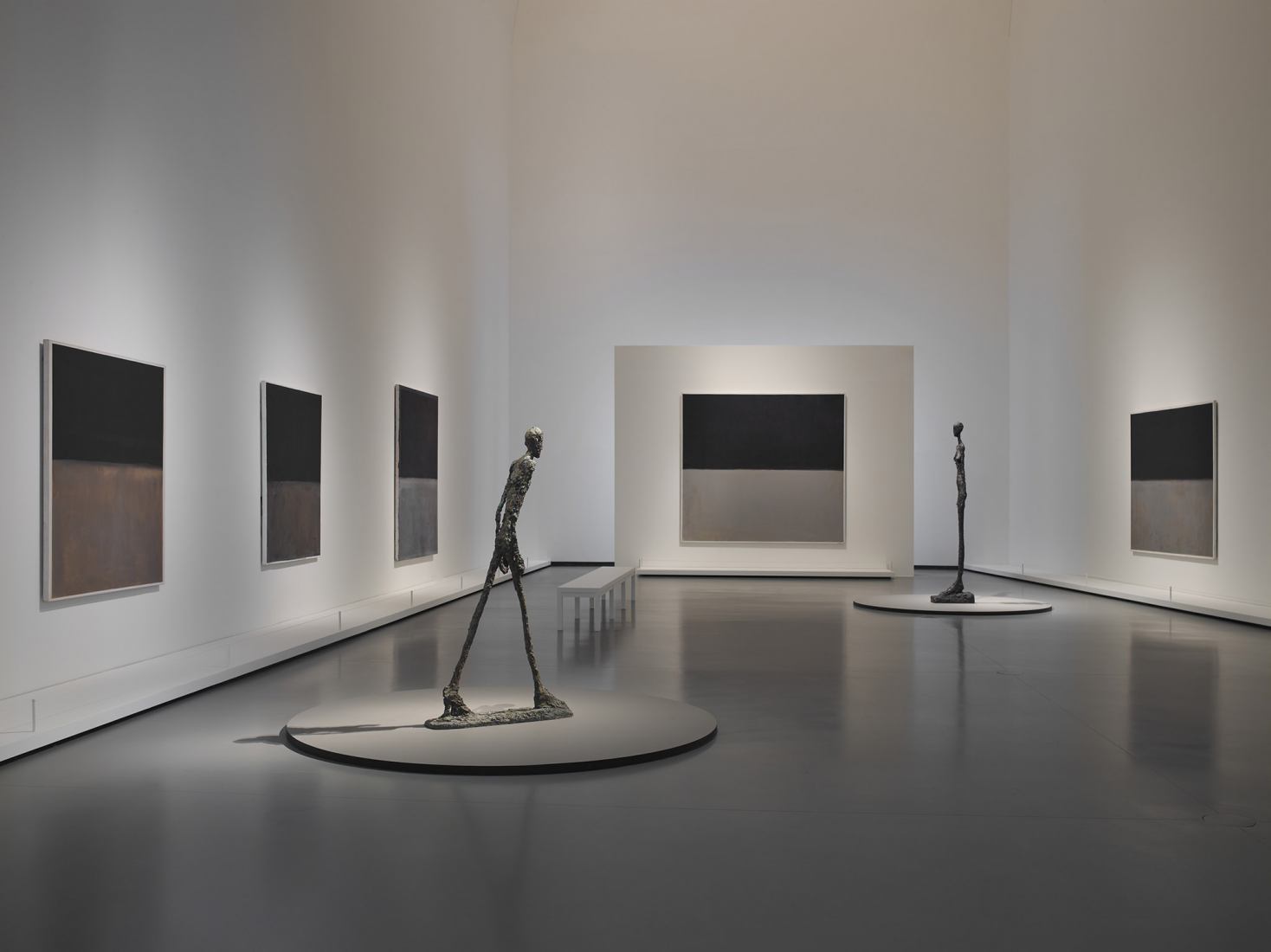 Left to right / Mark Rothko Untitled, 1969-1970 Untitled, 1969 Untitled, 1969 Untitled, 1969 Untitled, 1969 Sculptures / Alberto Giacometti L'Homme qui marche I, 1960 Grande Femme III, 1960. The first retrospective in France dedicated to Mark Rothko, at the Louis Vuitton Foundation. Courtesy of Louis Vuitton Foundation.