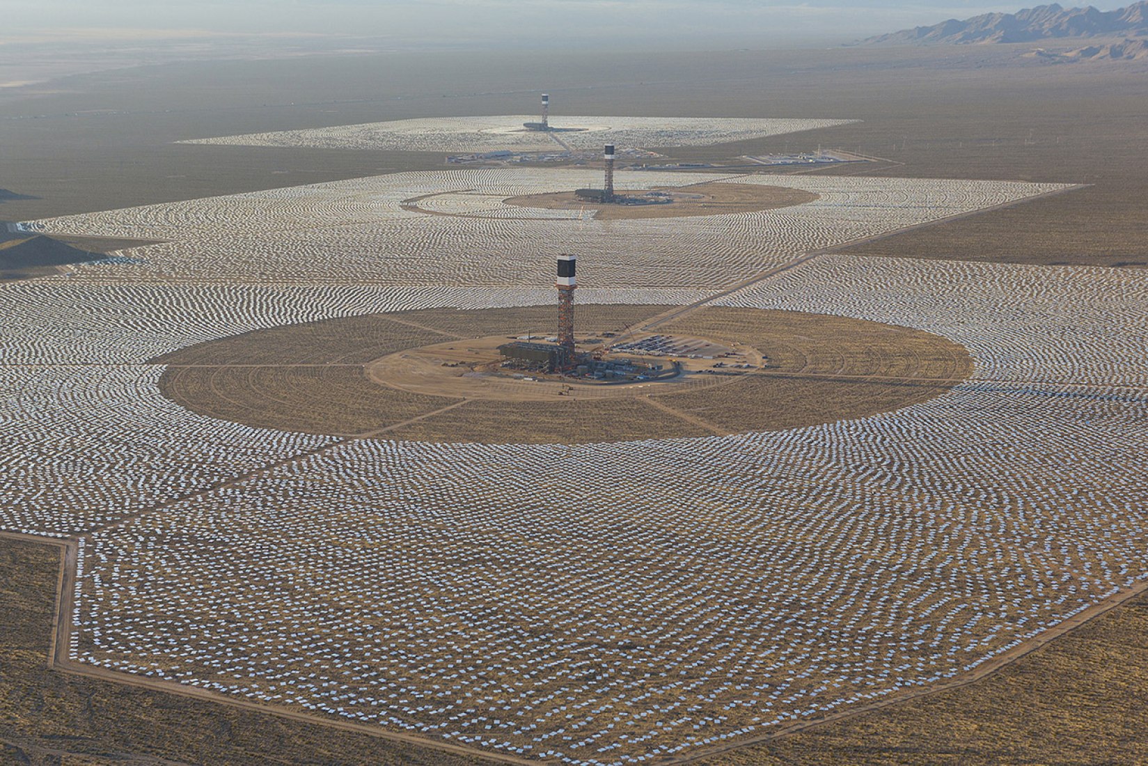 An aerial view of the Ivanpah Solar Electric Generating System with Tower 3 in the foreground, Tower 2 in the middle and Tower 1 in the background. Image courtesy of Ivanpah. 