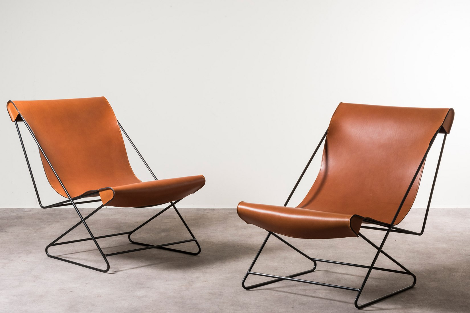 Pair of deckchairs designed for Casa Valéria Cirell, Morumbi-São Paulo. Design: Lina Bo Bardi Brazil, after 1958. Only a pair of deckchairs known Iron, removable leather upholstery. With the support of Instituto Bardi | Casa de Vidro 65.5 x 110 x h 86 cm (25.8 x 43.3 x h 33.9 in). Photograph by Daniele Iodice. Image courtesyof Nilufar Gallery, Milan