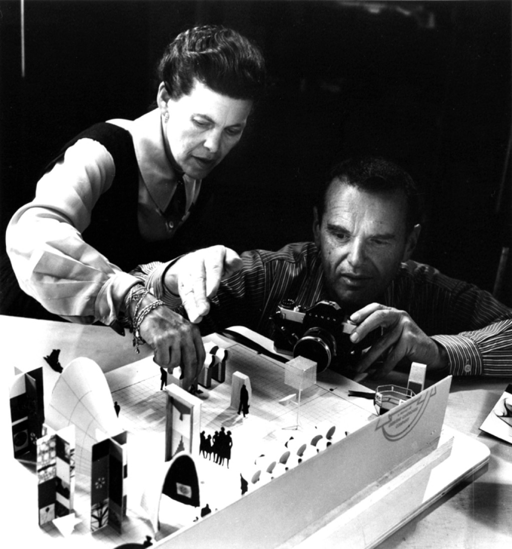 Charles and Ray Eames photographing an early model of the exhibition "Mathematics: A World of Numbers… and Beyond", 1960, as seen in Jason Cohn and Bill Jersey's documentary "EAMES: The Architect and the Painter. © 2011 Eames Office, LLC.  