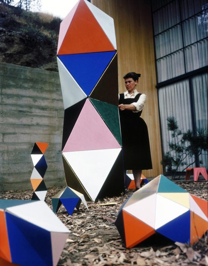 Ray Eames with and early prototype version of The Toy that was made of cardboard triangles, outside the Eames House, 1951, as seen in Jason Cohn and Bill Jersey's documentary "EAMES: The Architect and the Painter. © 2011 Eames Office, LLC.