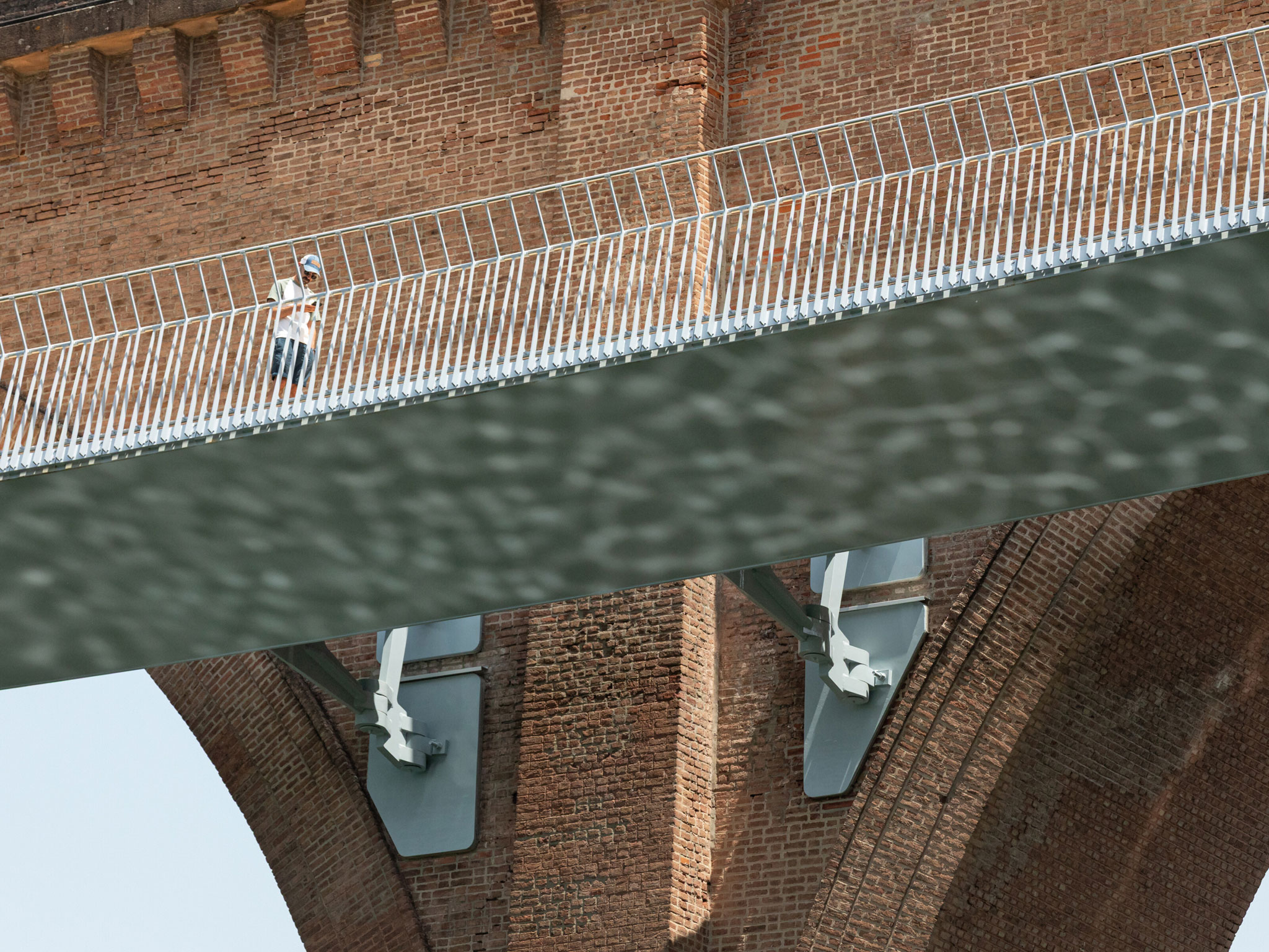 The steel structure is made of variable triangular boxes, whose minimum width is at the height of the viaduct piers, while below each arch, it widens to form the terraces. At its ends, the footbridge rests on two concrete pillars integrated into the embankments on the banks of the Tarn River.  The practice previously collaborated with William Matthews, designing the Tintagel Castle Bridge in Cornwall, from two cantilevered sections of 30 metres each, which do not meet in the middle. Other footbridges featured on METALOCUS include a Balingen footbridge in Germany and the Kiss Bridge in Pilar de la Horadada, Valencia, Spain.