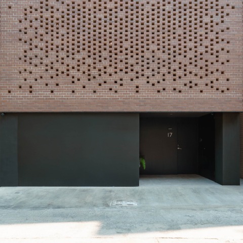 The Veil House by Paperfarm: a compact life enveloped by a brick