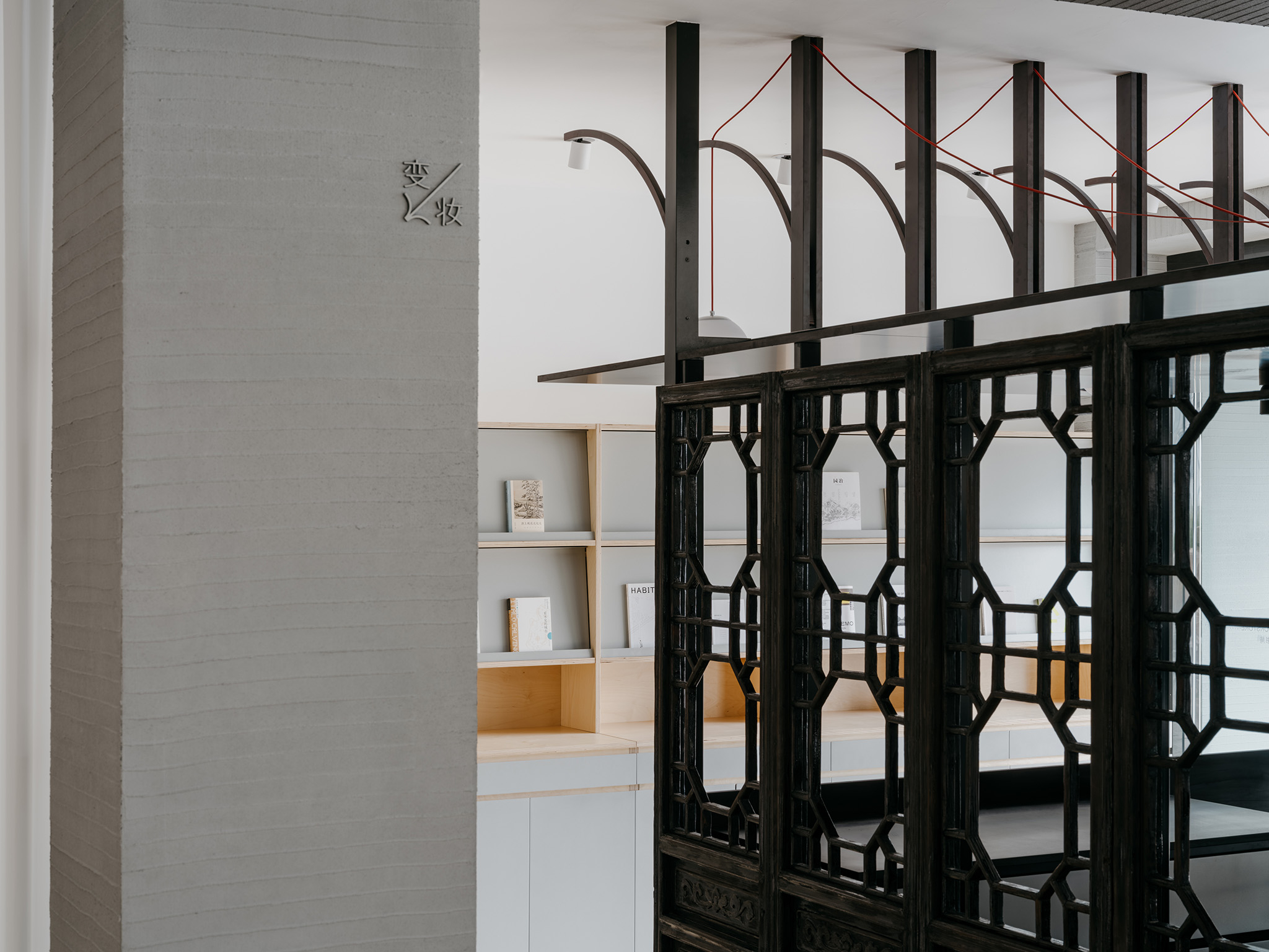 The north side of the Tangmingdan is clad with reclaimed wooden doors, charred to reveal their grain and renewed with a warm wooden tone. Baihua Bookstore by Tsing-Tien Making. Photograph by Wen Studio. 