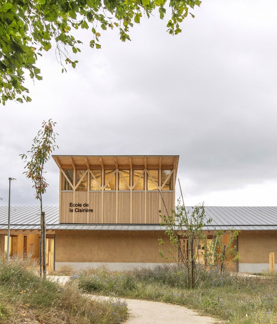 Construcción de una escuela de tierra cruda con cocina central por Tracks Architectes. Fotografía por Guillaume Amat