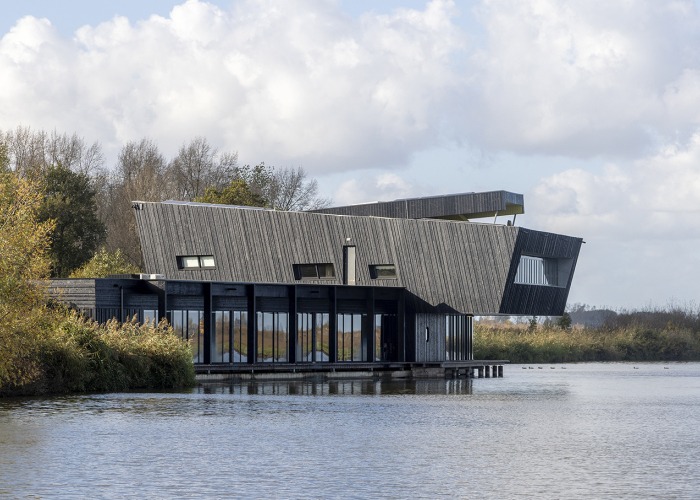View from the water. Expansion of NBC de Oostvaarders by Woonwerk Architecten. Photograph by Luuk Kramer