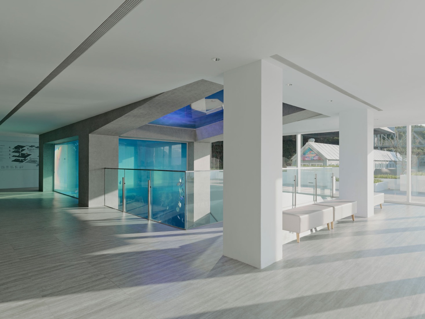 Gray concrete tank within the white wolume. i Ocean Museum by B+P Architects. Photograph by Studio Millspace.
