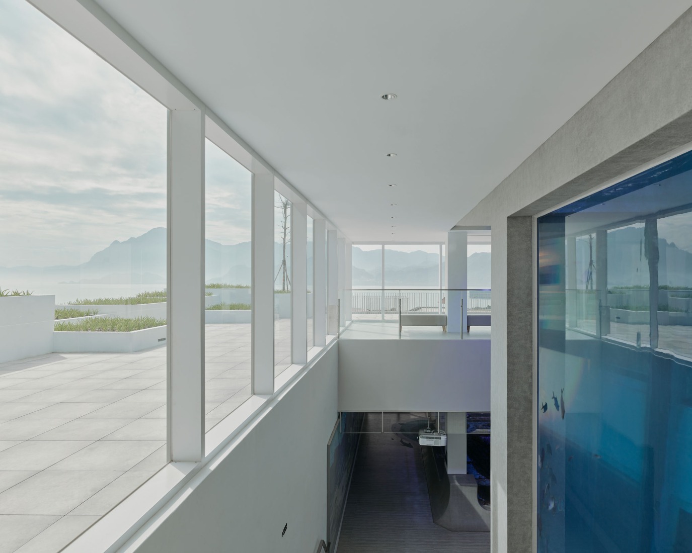 Gray concrete tank within the white wolume. i Ocean Museum by B+P Architects. Photograph by Studio Millspace.