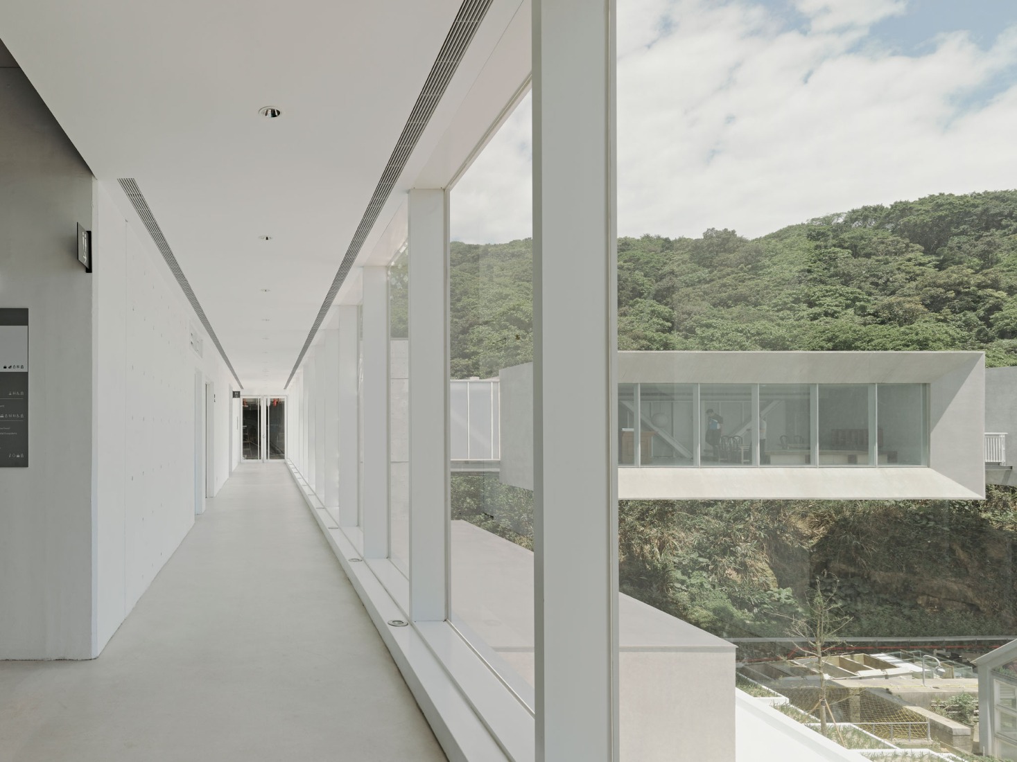 Completed glass curtain wall corridor. i Ocean Museum by B+P Architects. Photograph by Studio Millspace.