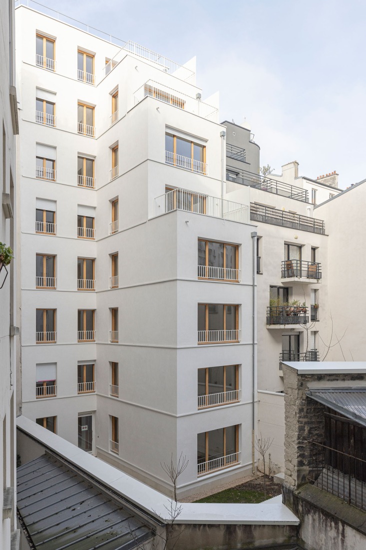 15 housing units in solid stone, timber and hemp concrete by MAO Architectes. Photograph by Cyrille Lallement.