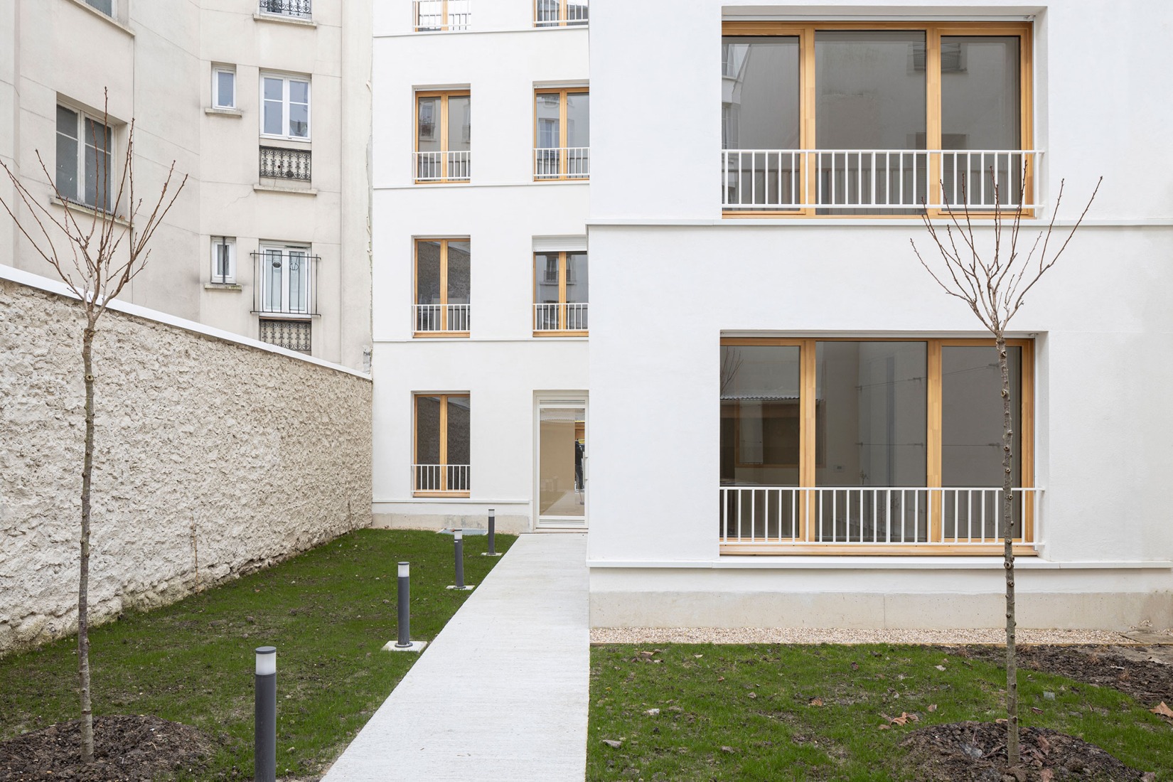 15 housing units in solid stone, timber and hemp concrete by MAO Architectes. Photograph by Cyrille Lallement.