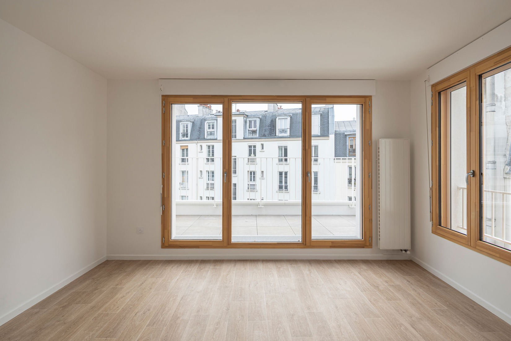 15 housing units in solid stone, timber and hemp concrete by MAO Architectes. Photograph by Cyrille Lallement.