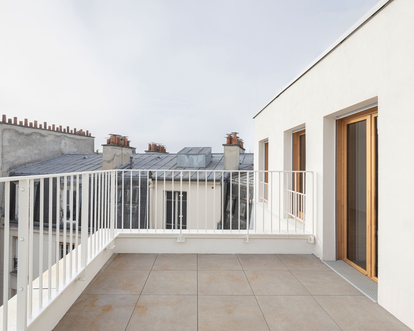 15 housing units in solid stone, timber and hemp concrete by MAO Architectes. Photograph by Cyrille Lallement.