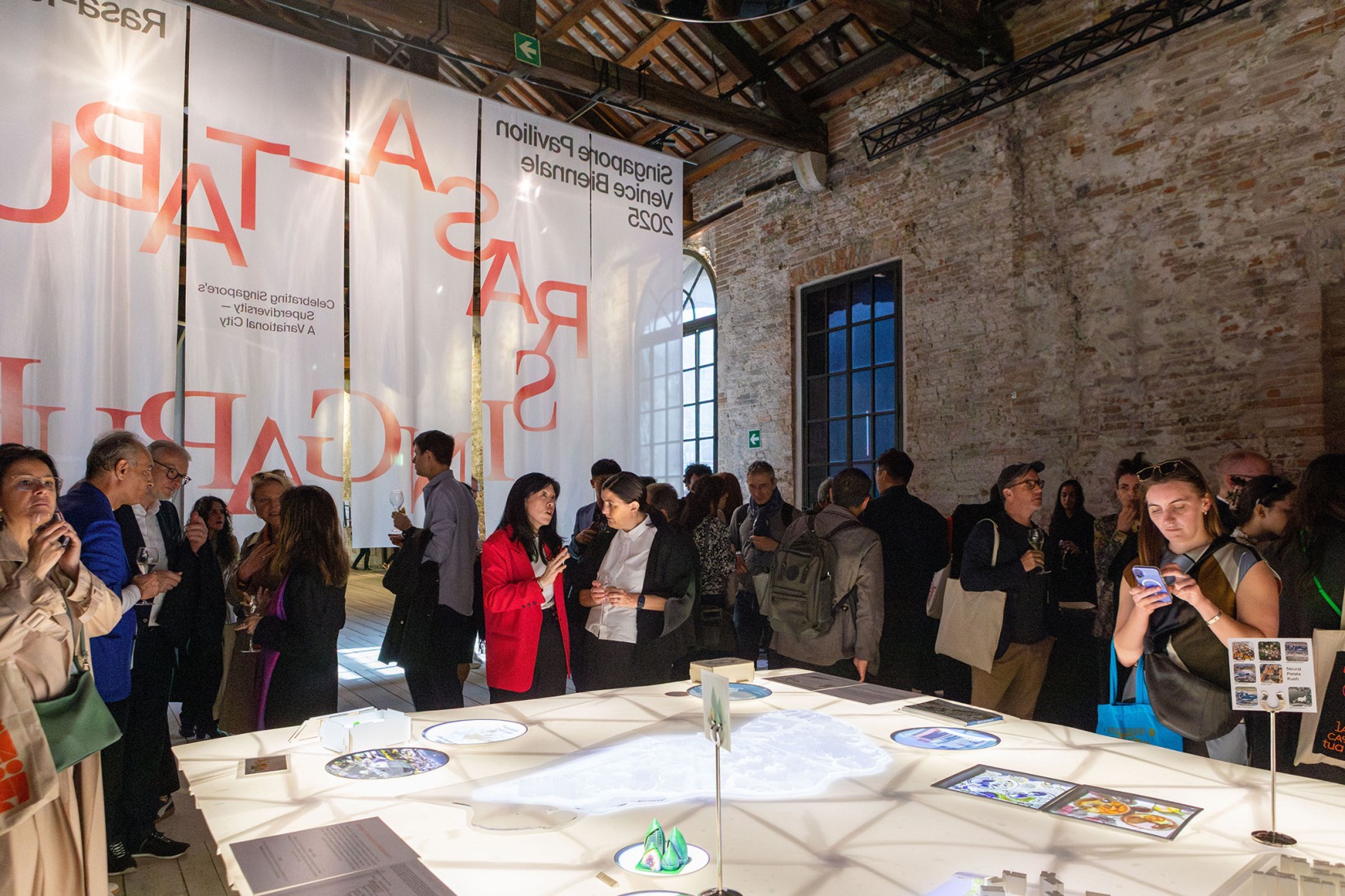 International visitors taking in the exhibition "Rasa-Tabula-Singapura" at the Singapore Pavilion, located at the Arsenale in Venice, as part of the 19th International Architecture Exhibition – La Biennale di Venezia. Photograph by Giulio Boem.
