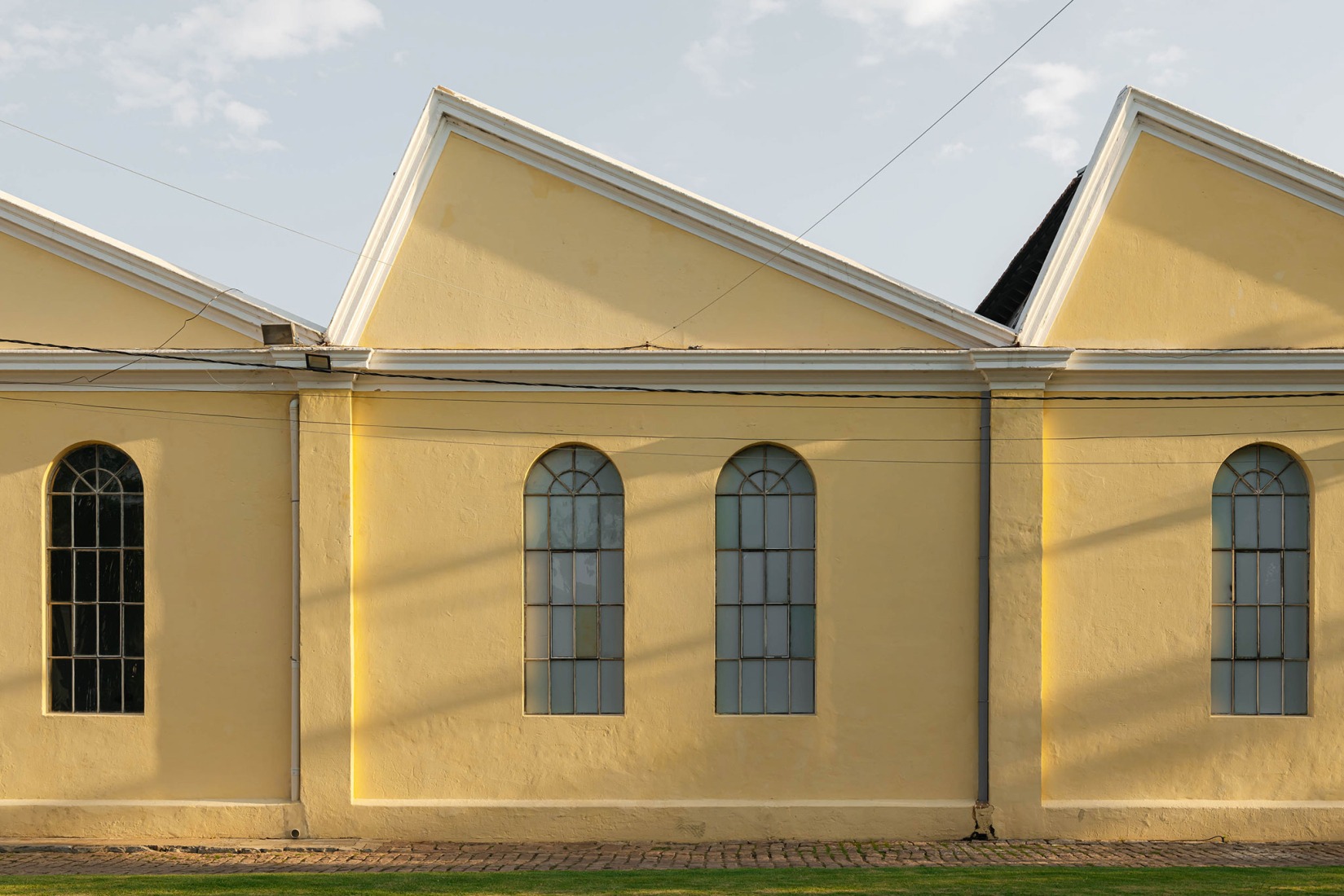 Façade of the Exhibition Building M from the patio. Fábrica de Arte Marcos Amaro (FAMA) by KAAN. Photograph by Sebastian van Damme.
