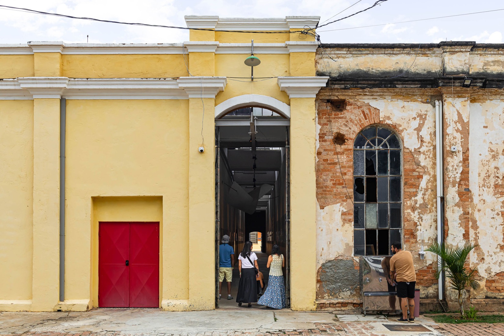 Façade of the Exhibition Building M and A. The first one restored, the second one still untouched. Fábrica de Arte Marcos Amaro (FAMA) by KAAN. Photograph by Sebastian van Damme.
