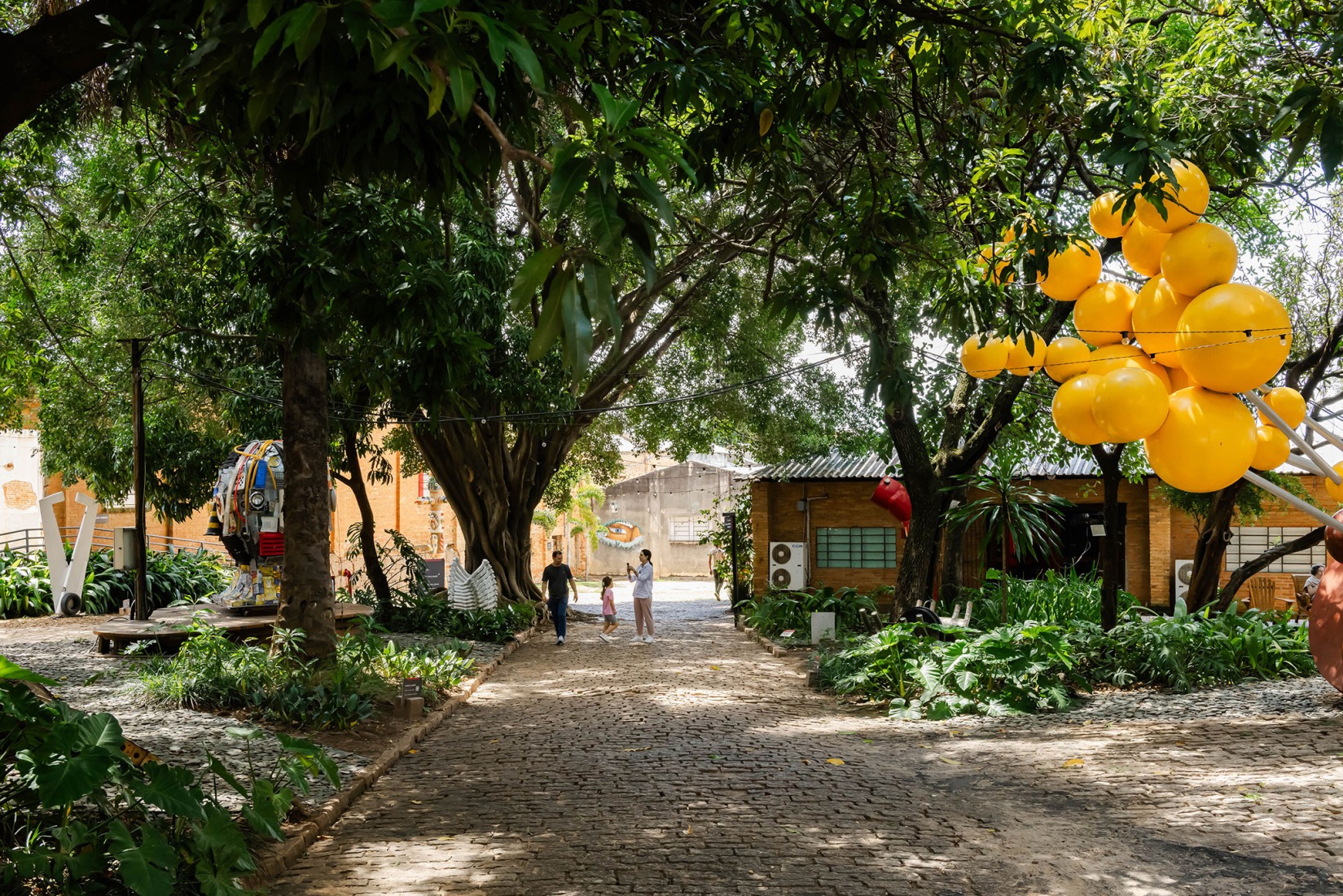 View of the green space between the Outdoor Exhibition G, the Depot F and the Temporary Exhibition Building H. Fábrica de Arte Marcos Amaro (FAMA) by KAAN. Photograph by Sebastian van Damme.