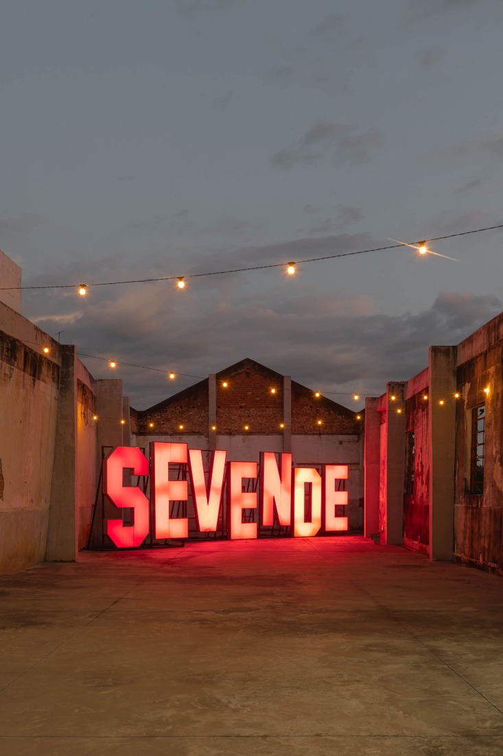View of the Outdoor Exhibition G, featuring Se vende (2008) by Carmela Gross. Luminous installation, aluminium and acrylic 308 × 1352 × 100 cm. Fábrica de Arte Marcos Amaro (FAMA) by KAAN. Photograph by Sebastian van Damme.