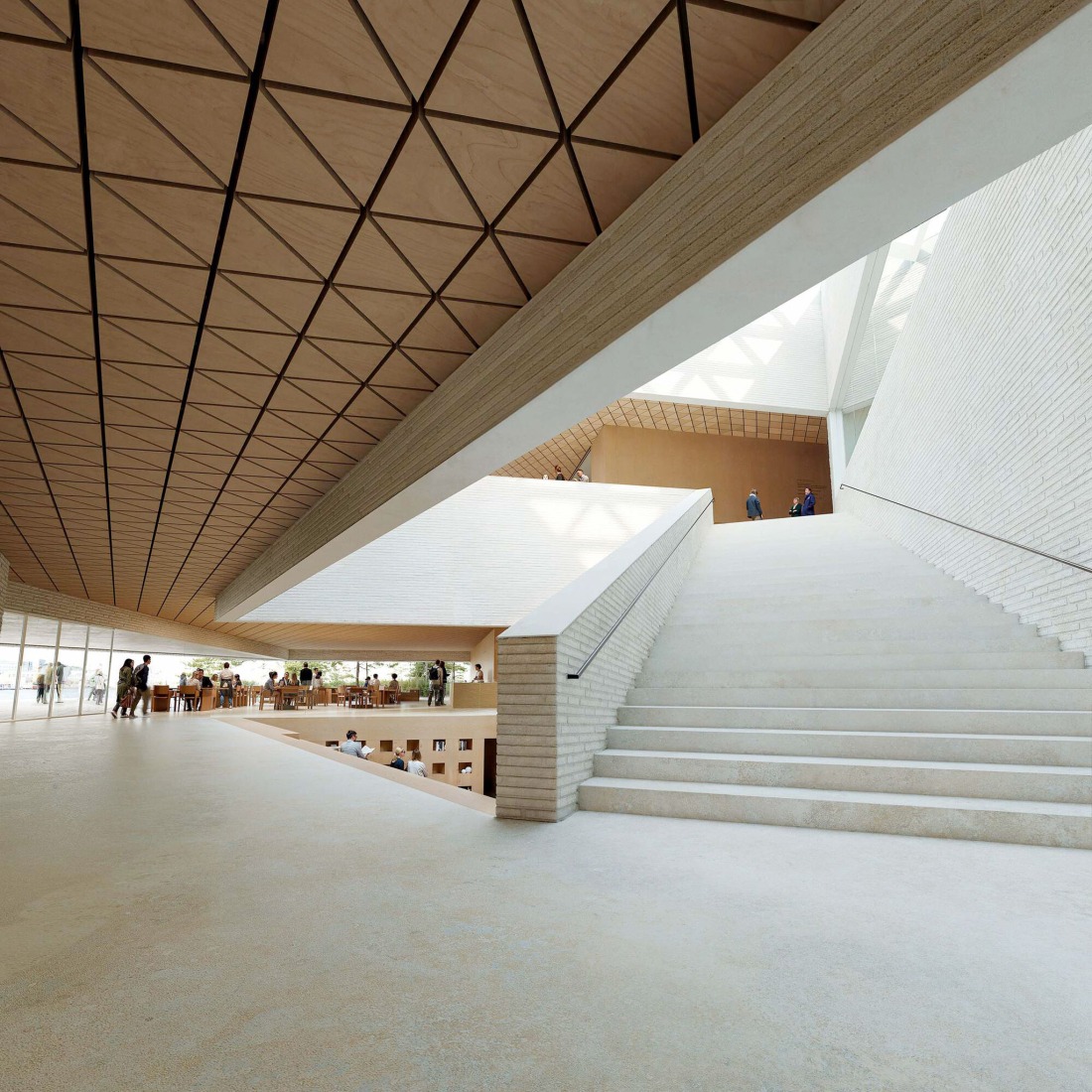 Vista desde el acceso hacia el restaurante y la colección de la biblioteca en la zona de acceso. Nuevo Museo de Arquitectura y Diseño de Helsinki. Proyecto ganador: Kumma, por JKMM Architects. Visualización por MIR y JKMM Architects.