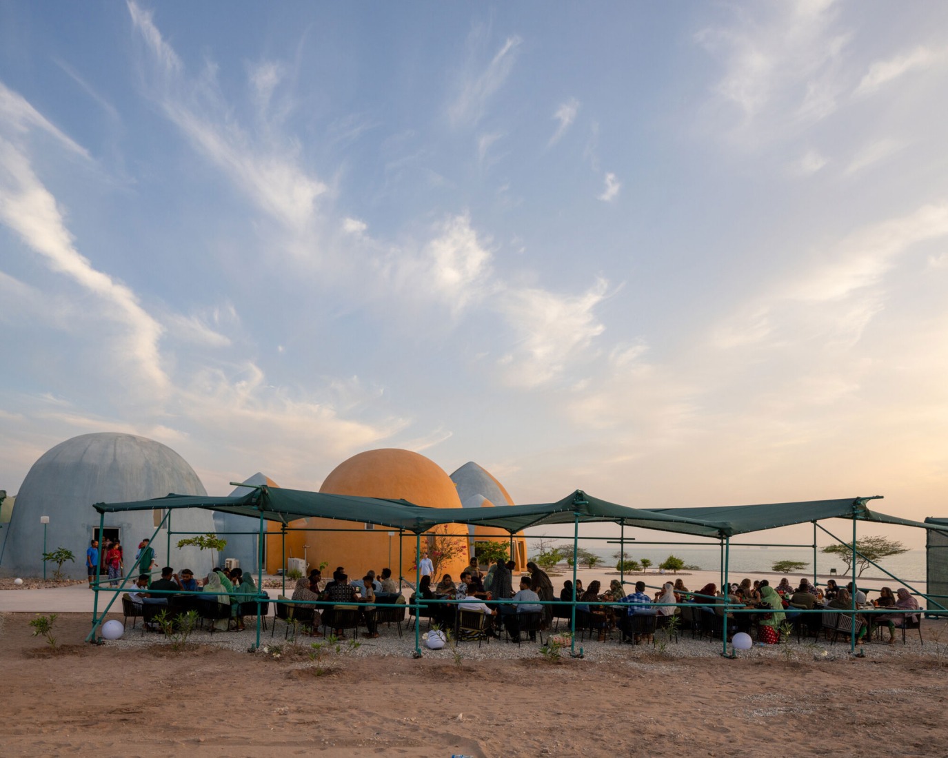 Visitors enjoying the terrace of one the several cafés at Majara Residence. Majara Residence and Community Redevelopment by ZAV Architects. Photograph by Deed Studio. Image courtesy of Aga Khan Trust for Culture. Visitors enjoying the terrace of one the several cafés at Majara Residence. Majara Residence and Community Redevelopment by ZAV Architects. Photograph by Deed Studio. Image courtesy of Aga Khan Trust for Culture.