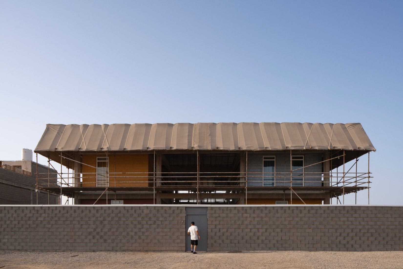Typeless is a two-storey building dedicated to education, comprising living spaces and workshops. It is a low-tech structure built with concrete, cement and scaffolding, using local know-how. All spaces are protected by a canopy roof, and can be modified and adapted to cater to the users' evolving needs. Majara Residence and Community Redevelopment by ZAV Architects. Photograph by Deed Studio. Image courtesy of Aga Khan Trust for Culture. Typeless is a two-storey building dedicated to education, comprising living spaces and workshops. It is a low-tech structure built with concrete, cement and scaffolding, using local know-how. All spaces are protected by a canopy roof, and can be modified and adapted to cater to the users' evolving needs. Majara Residence and Community Redevelopment by ZAV Architects. Photograph by Deed Studio. Image courtesy of Aga Khan Trust for Culture.