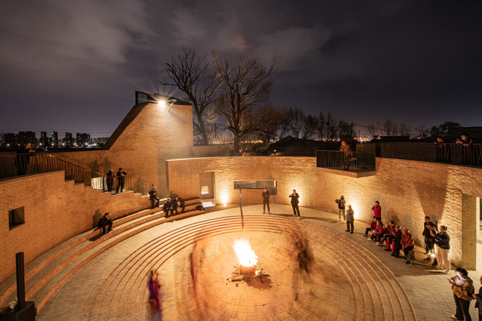 Performance around a fire in the courtyard of the community centre at night. Photograph courtesy by Aga Khan Trust for Culture / Dou Yujun (photographer).