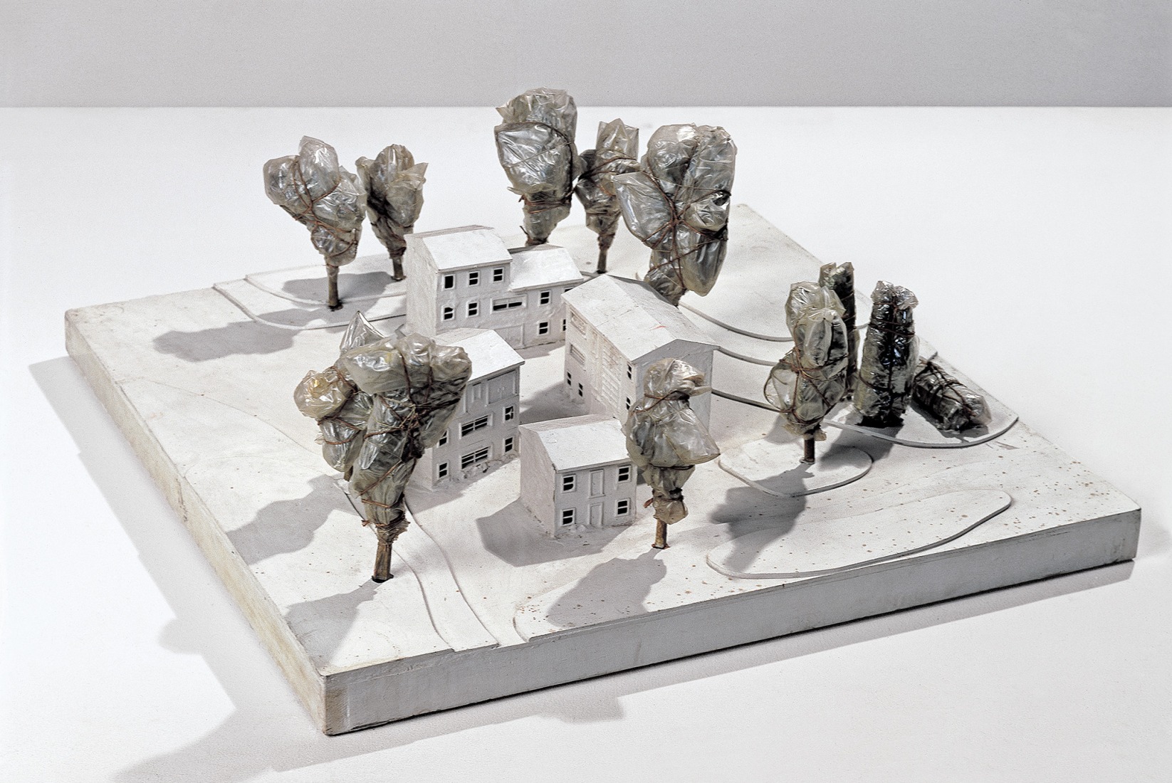 Christo and Jeanne-Claude. Wrapped Trees (Project for Forest Park, St. Louis, Missouri), 1966-67. Wood, enamel paint, plastic maquettes, acrylic paint, wire mesh, polyethylene, twine, staples, and nails. 29,2 × 76,2 × 76,2 cm (11 ½ × 30 × 30 inches). Photograph by Eeva-Inkeri. Courtesy by Christo and Jeanne-Claude Foundation / Prats Nogueras Blanchard Barcelona/Madrid.
