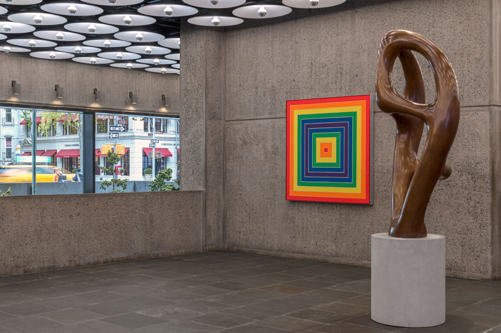 A view of the lobby with Frank Stella's Concentric Square (left) and Jean Arp's Ptolémée III (right). Photography by Max Touhey. Courtesy of Sotheby’s.