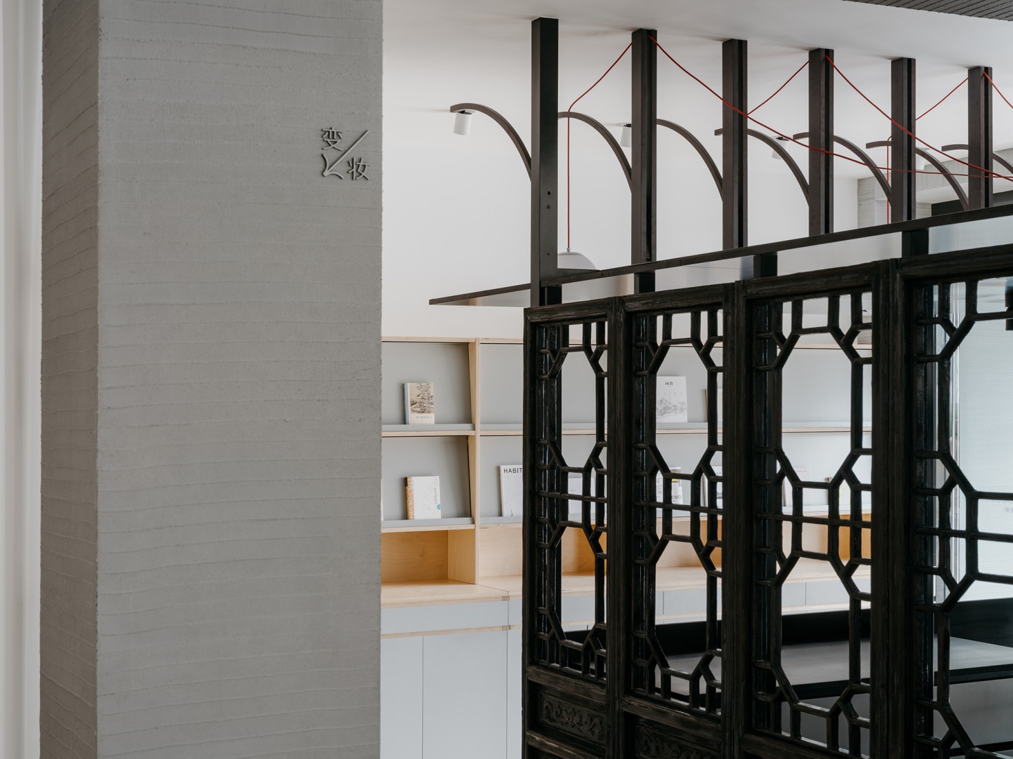 The north side of the Tangmingdan is clad with reclaimed wooden doors, charred to reveal their grain and renewed with a warm wooden tone. Baihua Bookstore by Tsing-Tien Making. Photograph by Wen Studio.