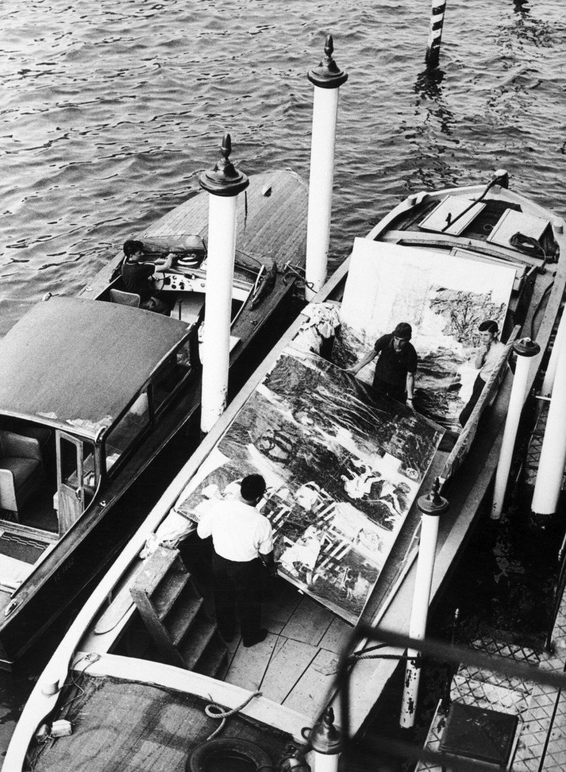 Robert Rauschenberg's “Express” (1963), “Studio Painting” (1960-61), and “Tree Frog” (1964) being transported by boat to the Giardini grounds during the 32nd Venice Biennale, Venice, Italy, June 1, 1964. Photograph by Ugo Mulas. Photograph Collection. Robert Rauschenberg Foundation Archives, New York. Courtesy of Museo Nacional Thyssen-Bornemisza, Madrid.