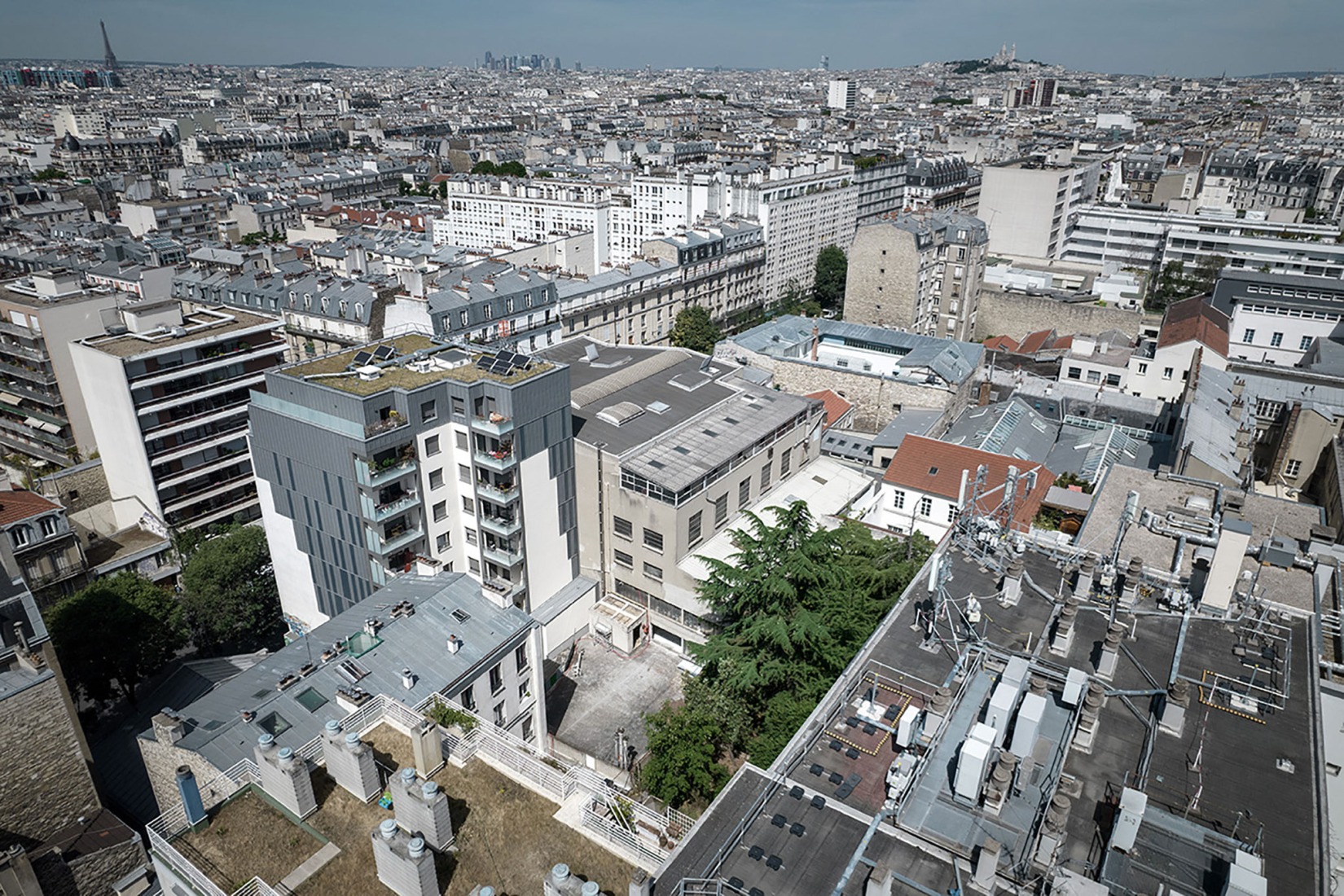 The building prior to its reconstruction from a garage into a 63 Apartment Building, by Atelier Tequi Architects. Photograph by Atelier Tequi Architects.