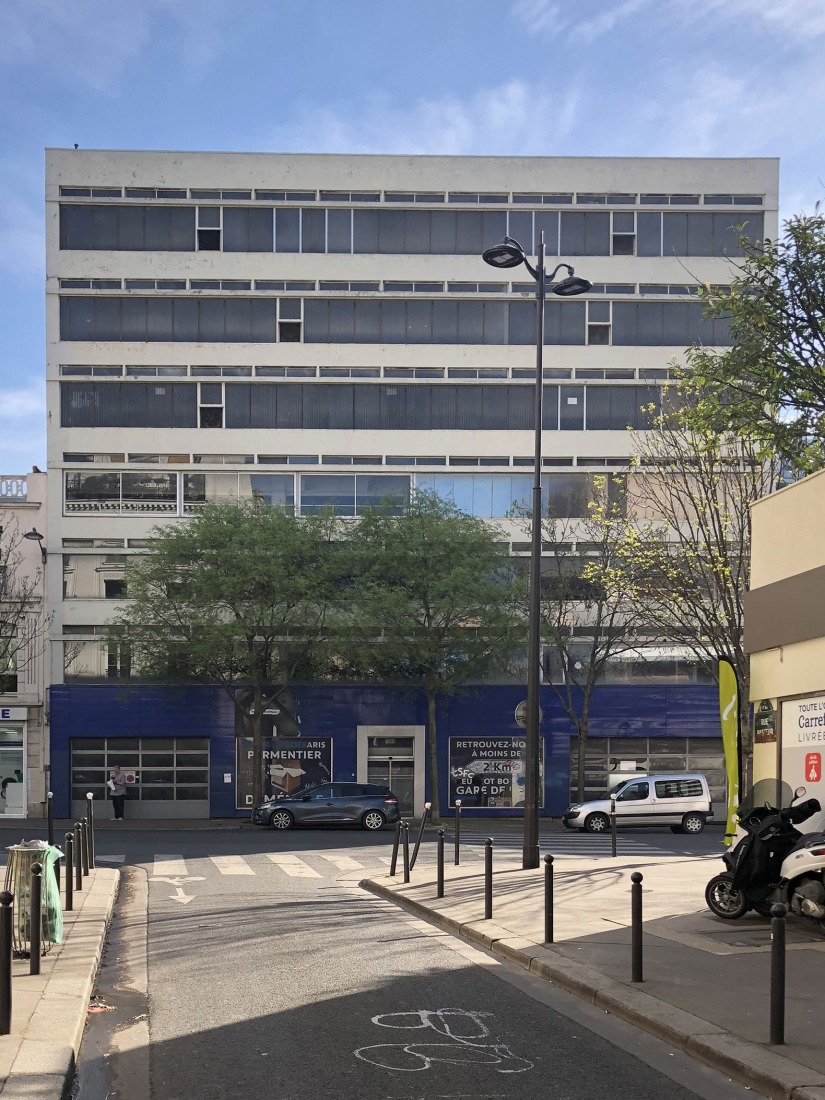 The building prior to its reconstruction from a garage into a 63 Apartment Building, by Atelier Tequi Architects. Photograph by Atelier Tequi Architects.