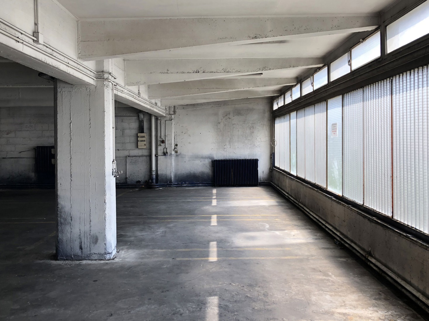 The building prior to its reconstruction from a garage into a 63 Apartment Building, by Atelier Tequi Architects. Photograph by Atelier Tequi Architects.