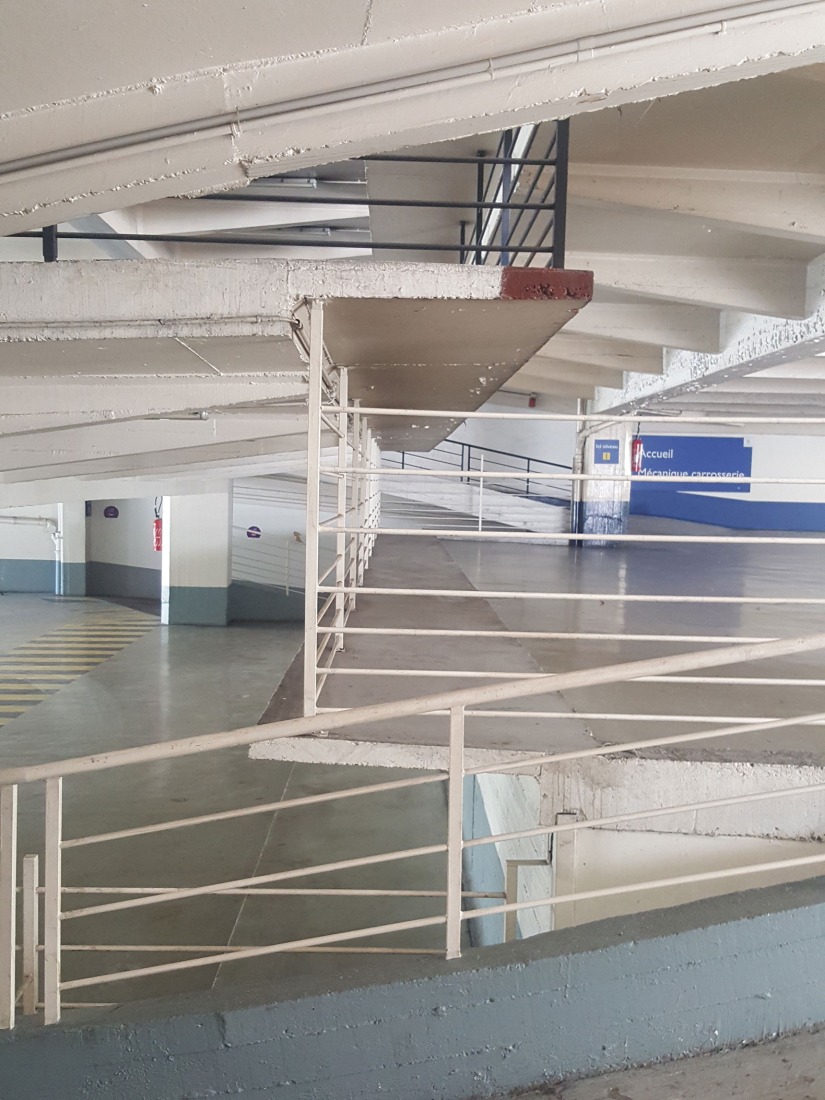 The building prior to its reconstruction from a garage into a 63 Apartment Building, by Atelier Tequi Architects. Photograph by Atelier Tequi Architects.