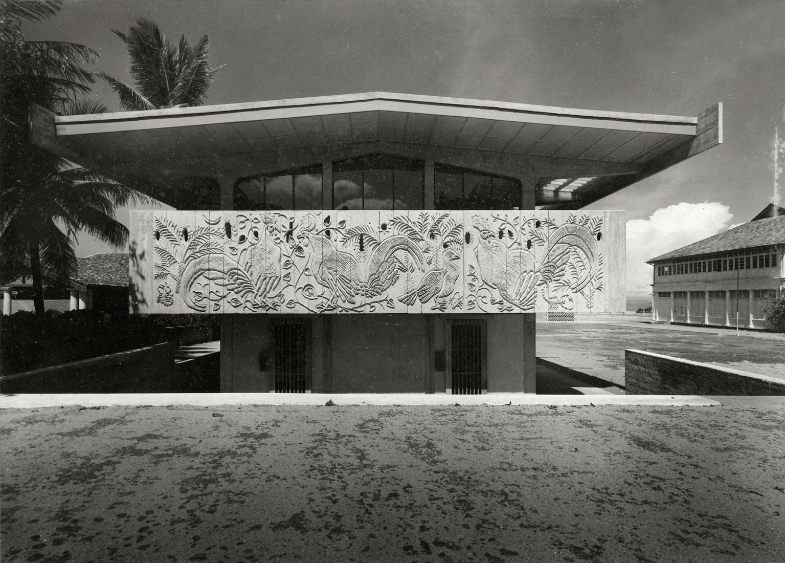 Exterior view of St. Thomas' Preparatory School showing basreliefs by Anil Gamini Jayasuriya, gelatin silver print. Photograph by Geoffrey Bawa, c. 1962. Courtesy by Geoffrey Bawa and Lunuganga Trusts, all rights reserved. 
