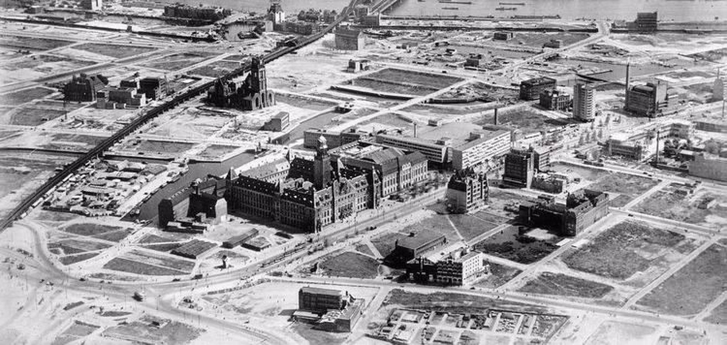Aerial photograph showing the historic center of Rotterdam immediately following the devastating German blitz on May 14, 1940, looking over the cleared rubble surrounding surviving landmarks like the Rotterdam City Hall on the Coolsingel.