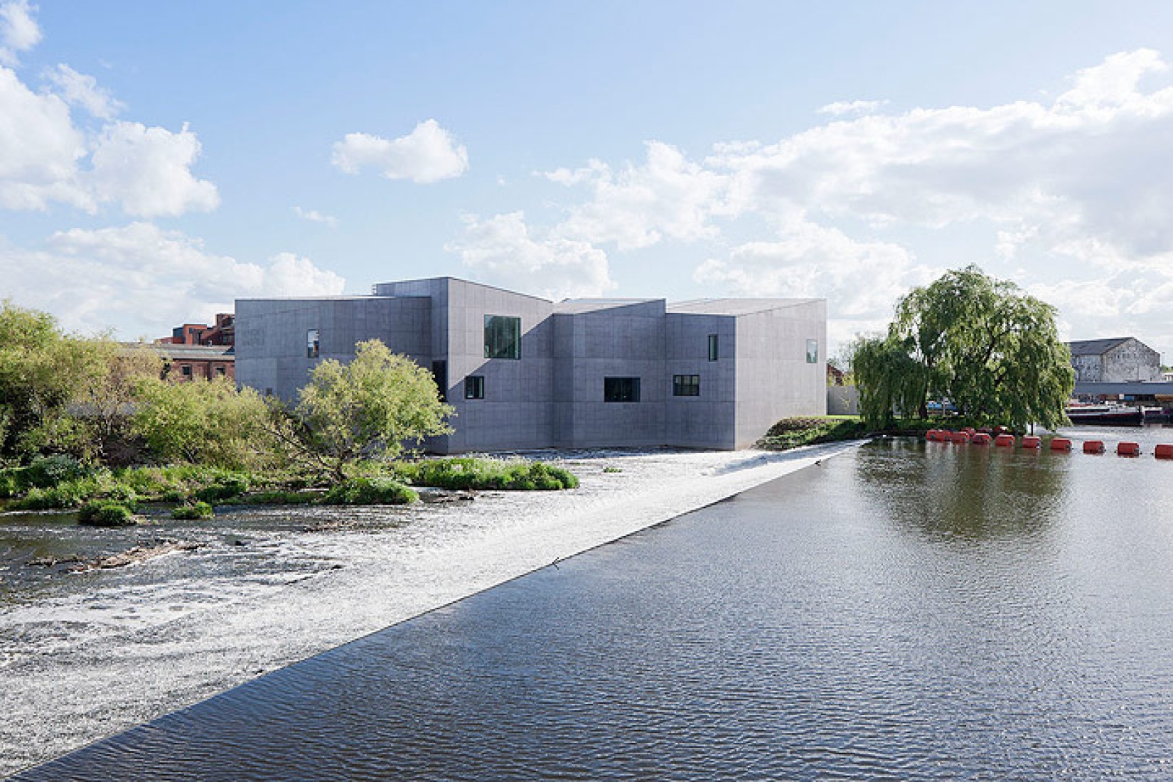 Exterior from water. The Hepworth Wakefield Gallery by David Chipperfield Architects. Photograph © Iwan Baan