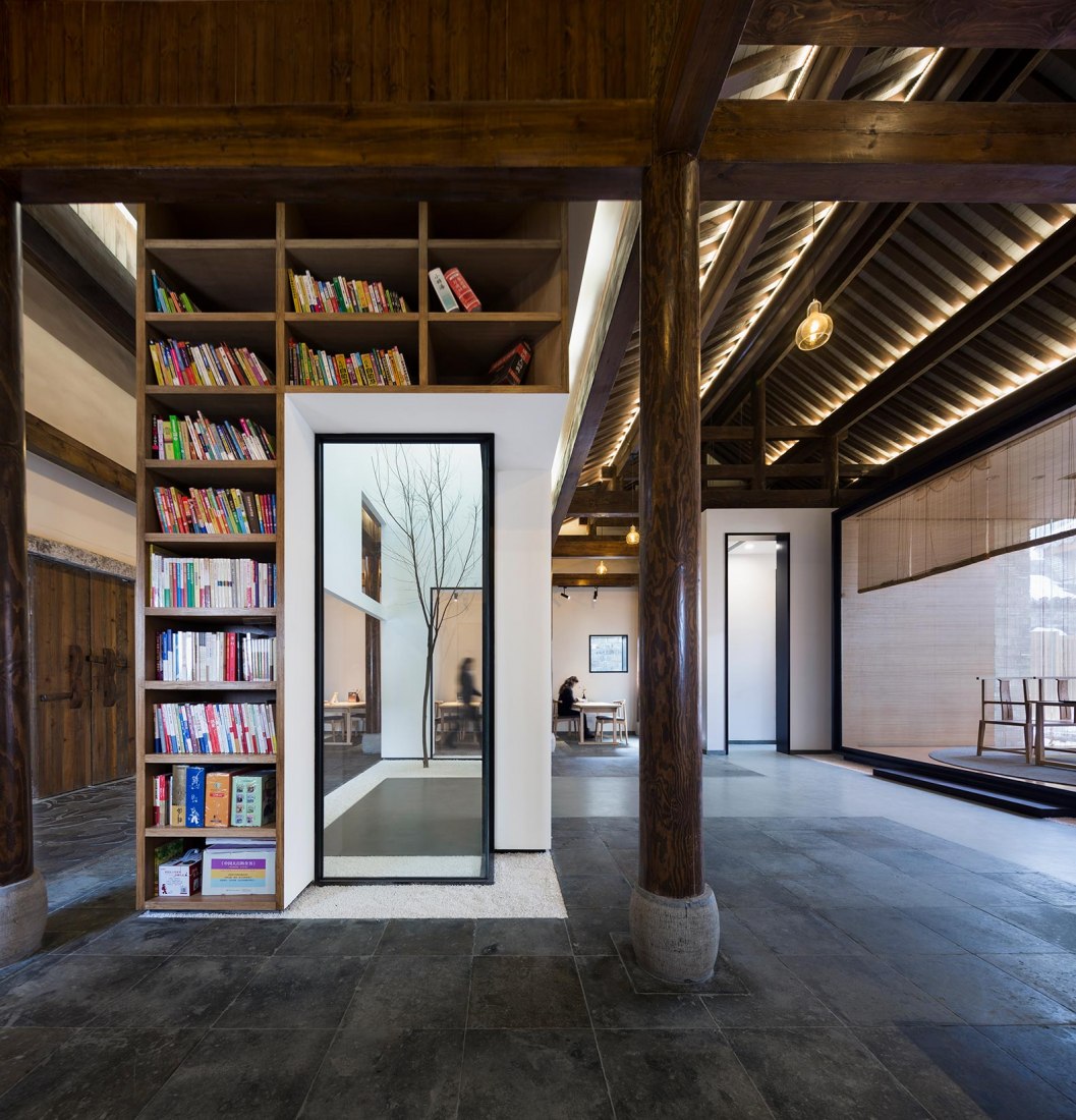 Booksshelves and patio. Jiangshan Fishing Village by Mix Architecture. Photograph by Hou Bowen