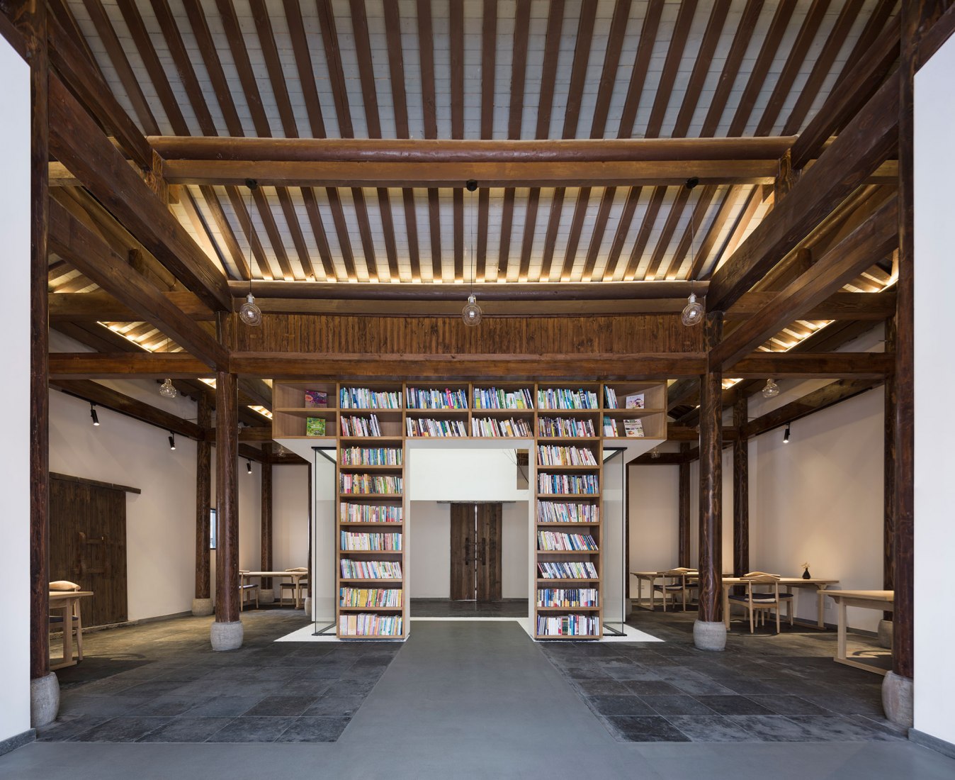 Blackview of lobby and shelves. Jiangshan Fishing Village by Mix Architecture. Photograph by Hou Bowen