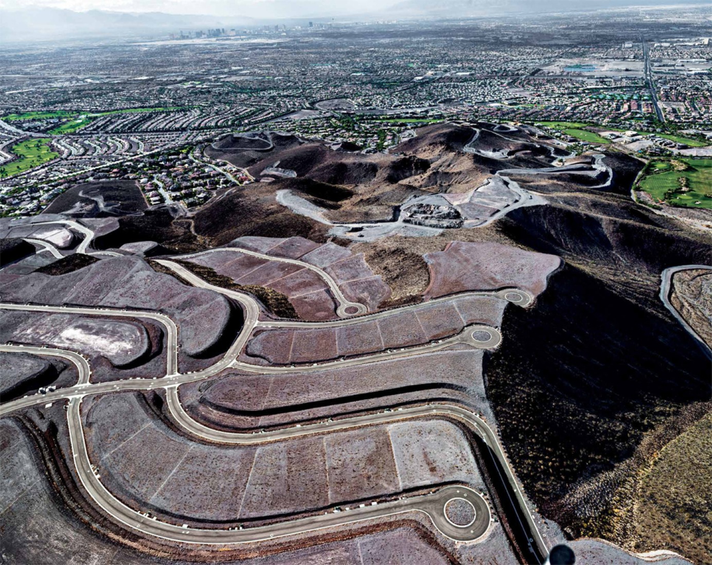 Unbuilt Ascaya lots and Cloudloft Court in foreground looking north, Sun City MacDonald Ranch development and downtown Las Vegas beyond, Henderson, Nevada; 2012. "Michael Light: Lake Las Vegas / Black Mountain." Photograph © Michael Light. Courtesy of Radius Books.