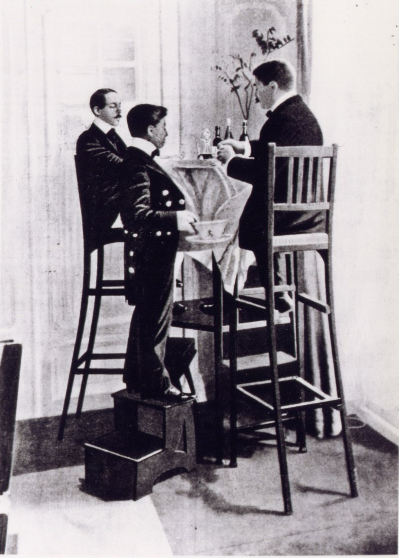 Alberto Santos-Dumont en su casa parisina, cenando con amigos sentados en muebles altos para que pudieran experimentar lo que era estar elevado sobre el suelo. Alrededor de 1900 Archivos Cartier. Fotografía © Cartier. Imagen cortesía Design Museum