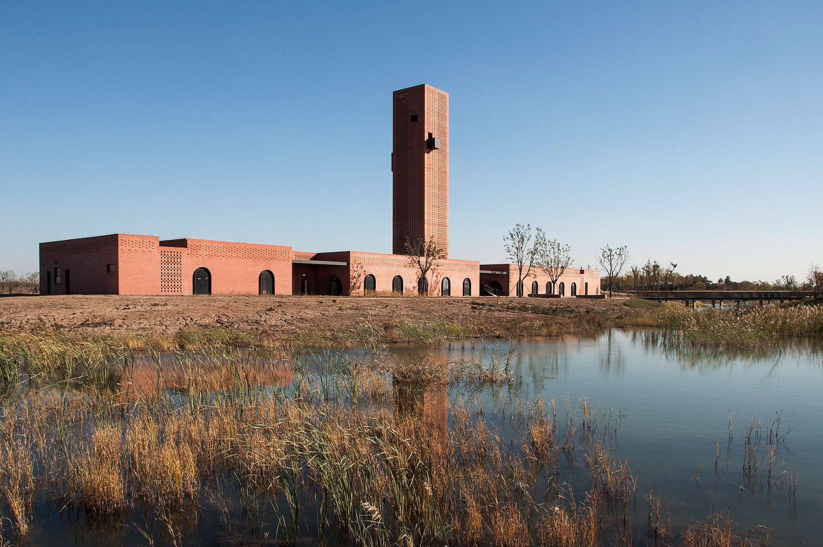 Overlooking west façade by the lake. Tower of Bricks by Interval Architects. Photograph by Zhi Geng