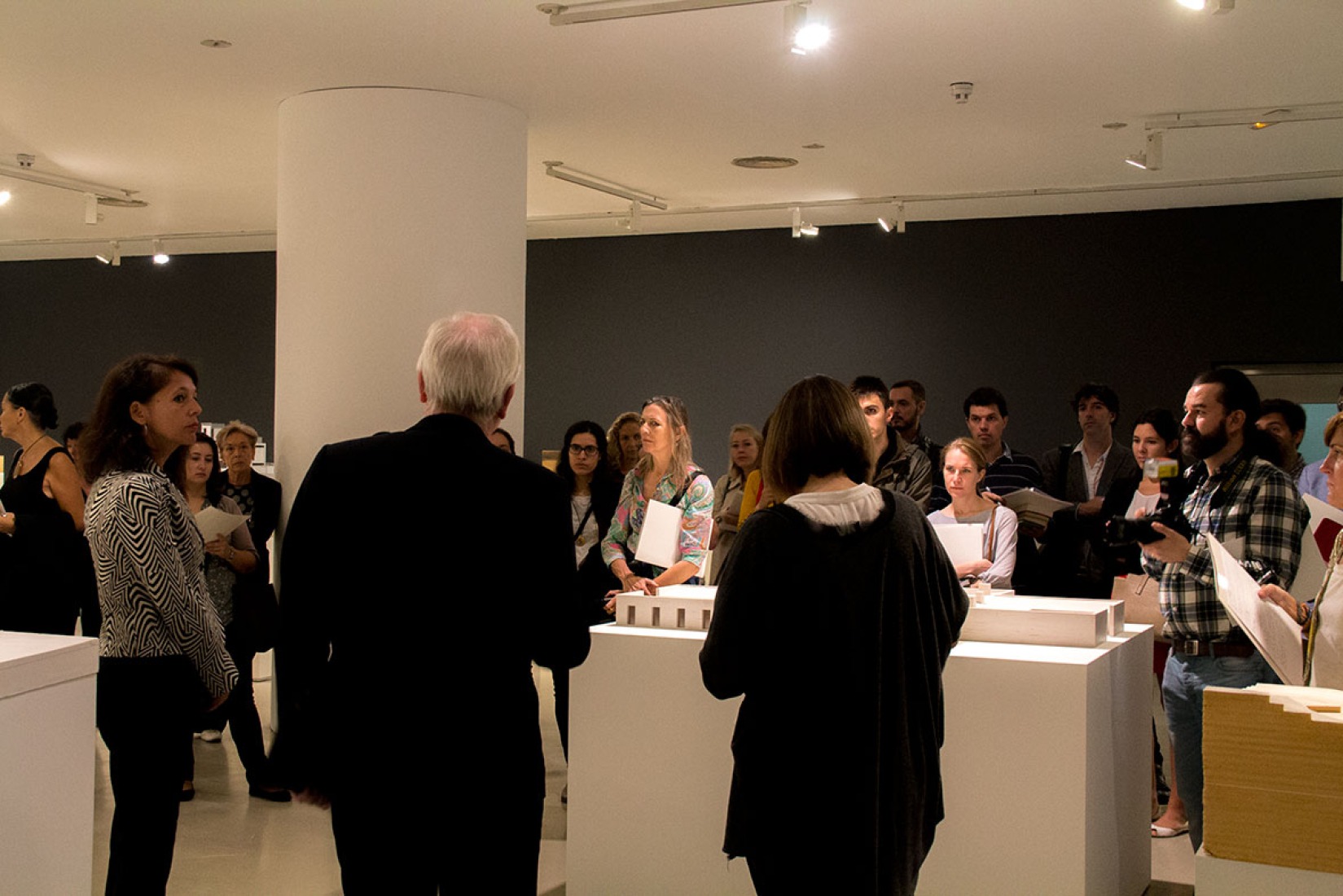 Exhibition room during the opening. "Essential. David Chipperfield Architects" Exhibition. Photography © Andrea Portillo / METALOCUS.