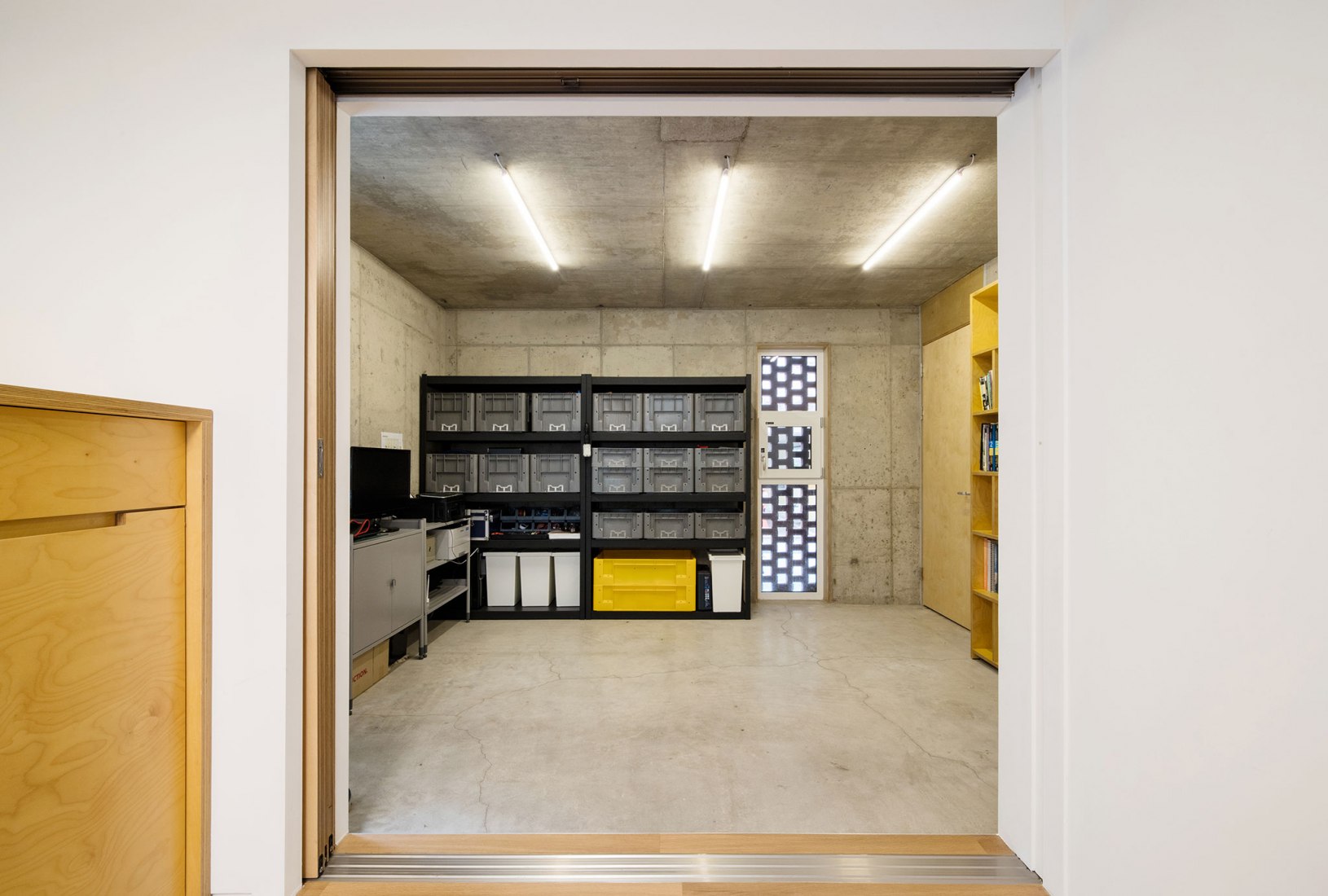 Workshop, ground floor level. Five story house by stpmj. Photograph by Bae Jihun