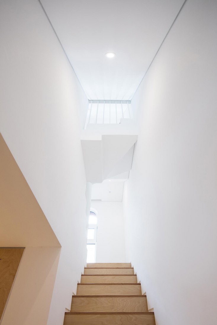 Staircase, third floor level. Five story house by stpmj. Photograph by Bae Jihun