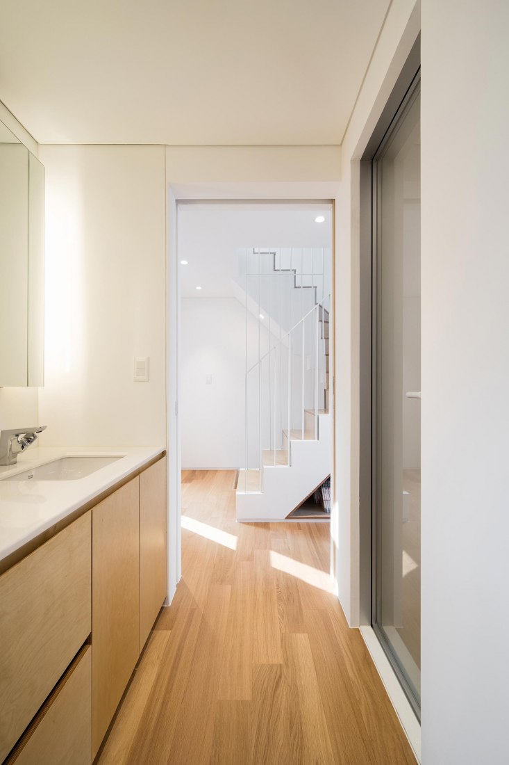 Bathroom, fourth floor level. Five story house by stpmj. Photograph by Bae Jihun